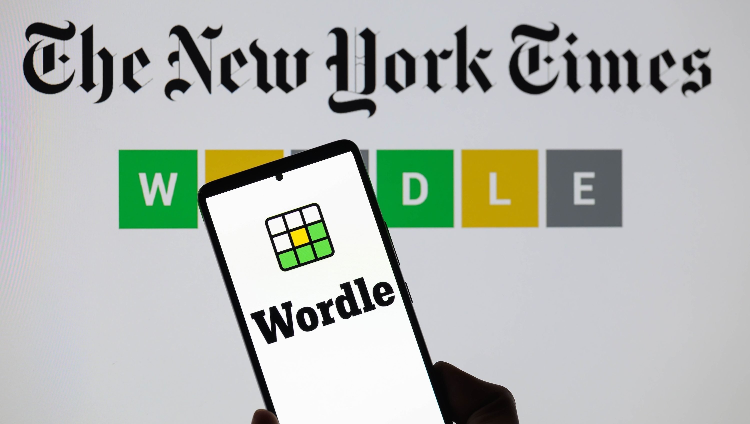 The Wordle logo is being displayed on a smartphone with The New York Times visible in the background in this photo illustration in Brussels, Belgium, on June 1, 2024. (Photo by Jonathan Raa/NurPhoto)