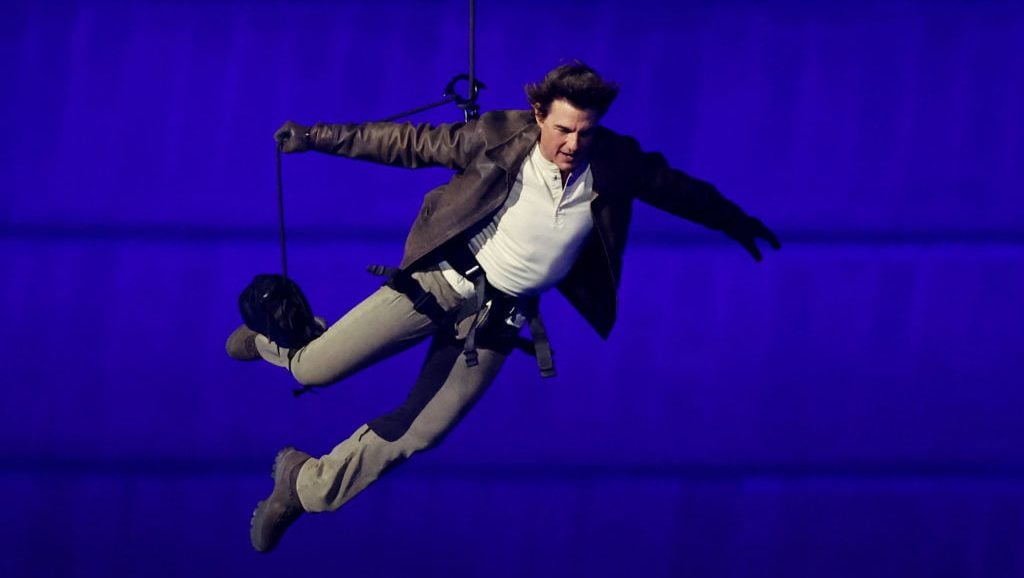 PARIS, FRANCE - AUGUST 11: Actor Tom Cruise jumps from the roof of the Stade de France during the Closing Ceremony of the Olympic Games Paris 2024 at Stade de France on August 11, 2024 in Paris, France. (Photo by Fabrizio Bensch- Pool/Getty Images)